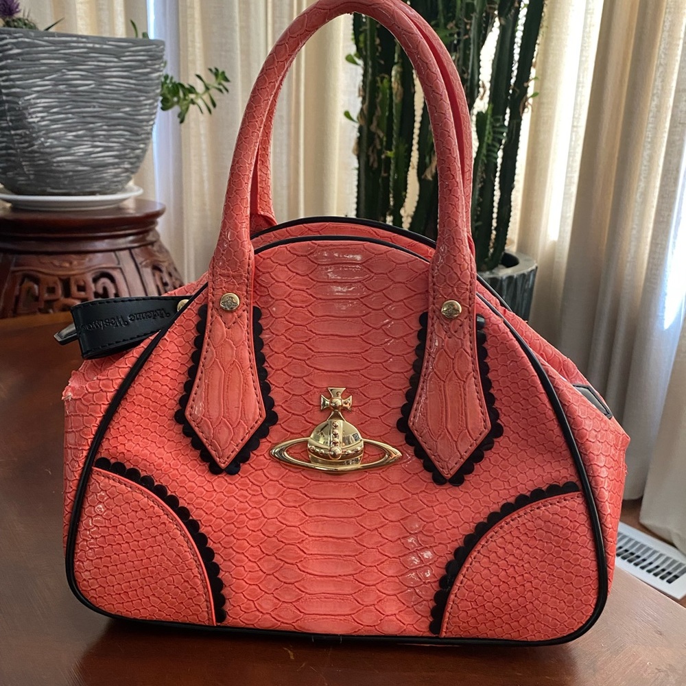 Authentic, gently loved, Viviane Westwood salmon colored purse.